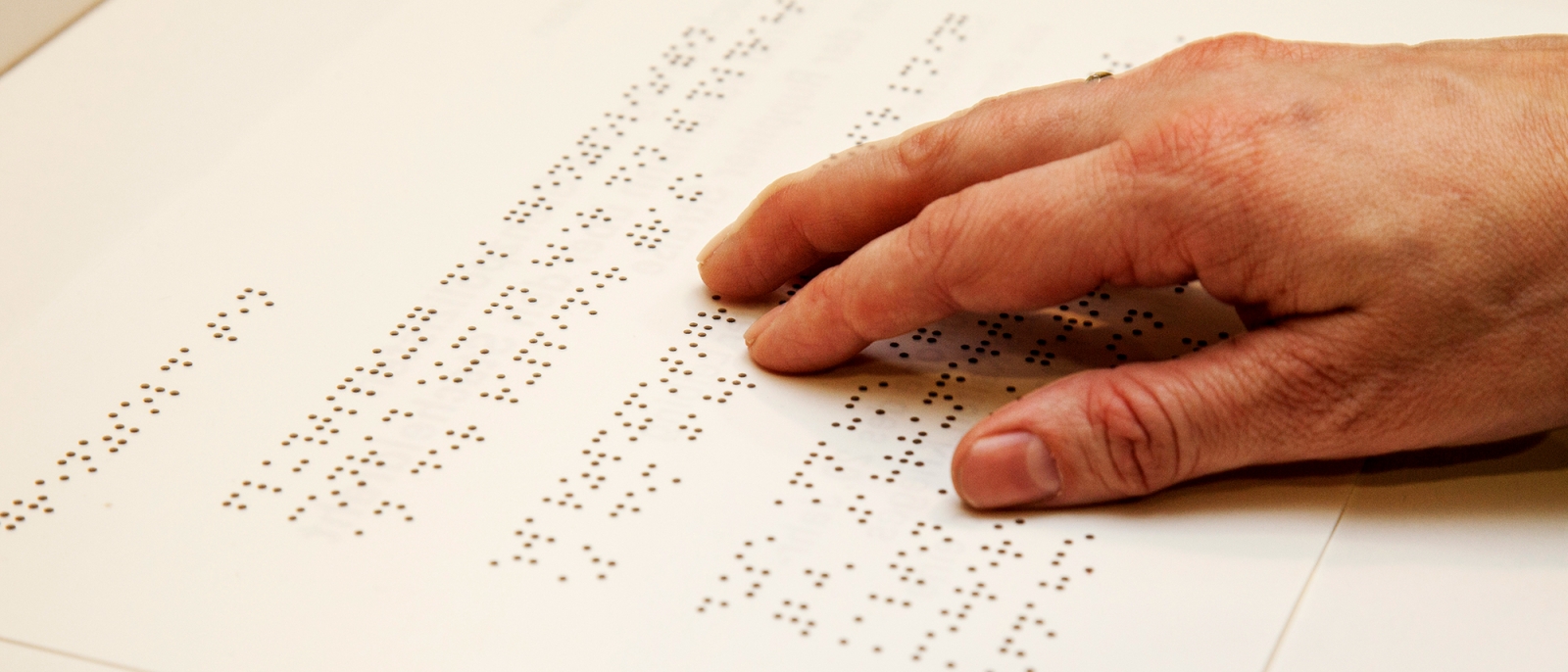 Hand reads Braille